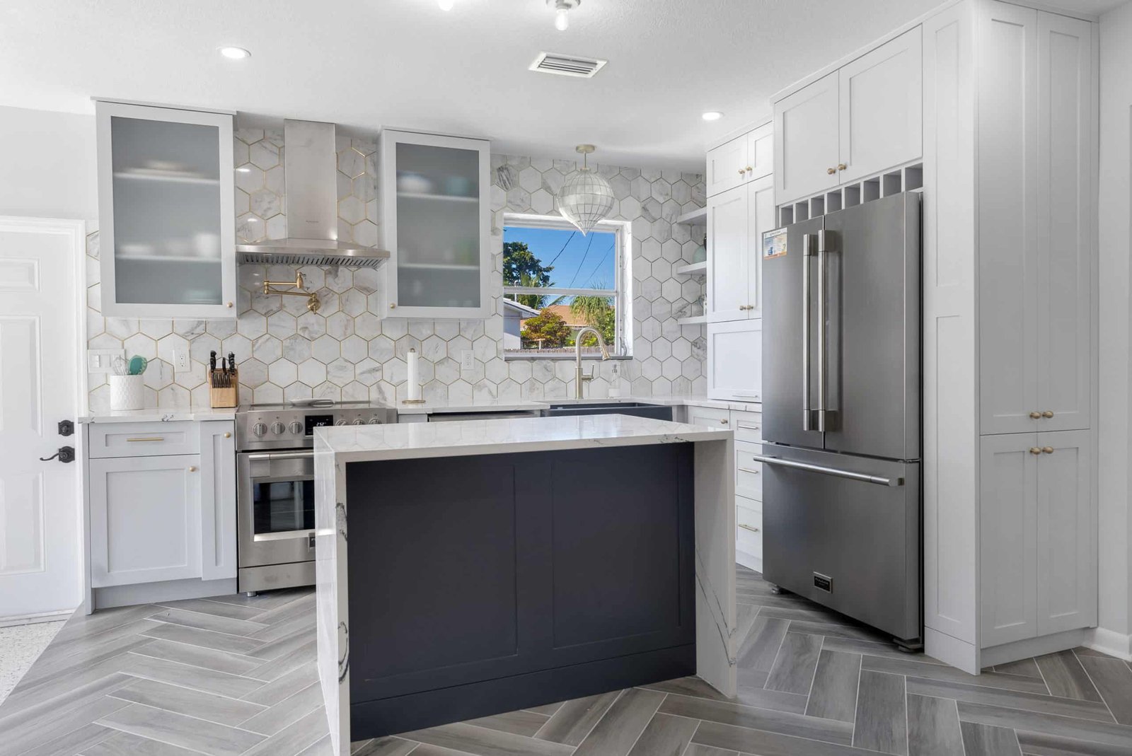 a kitchen with a white countertop and a gray island