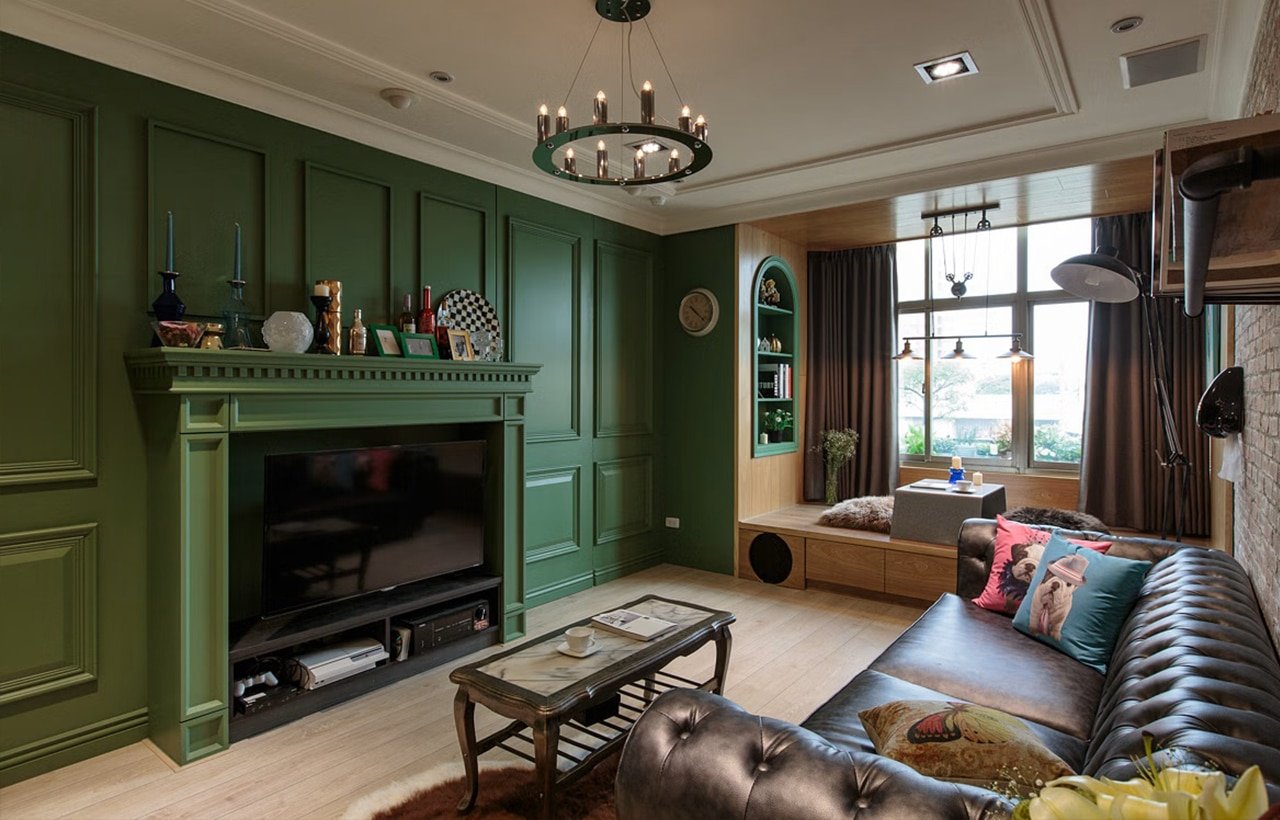 a living room with green walls and a couch